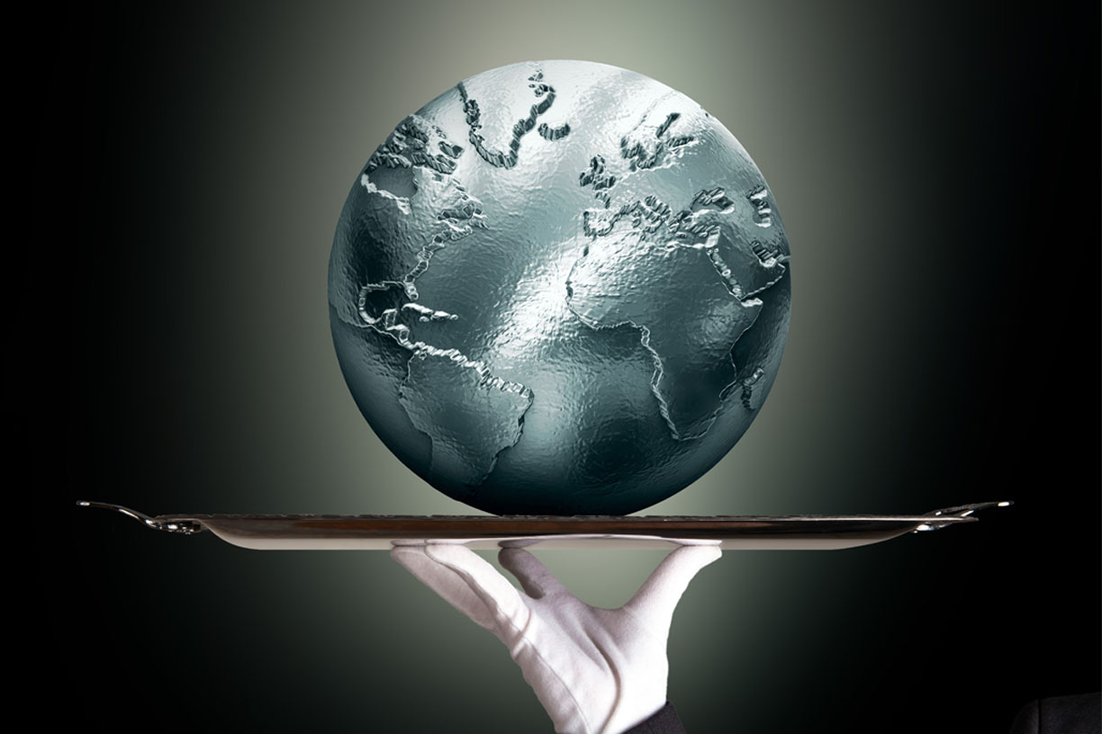 Gloved hand holding globe on platter